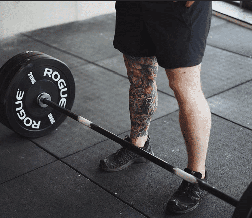 Man doing Romanian Deadlift in gym