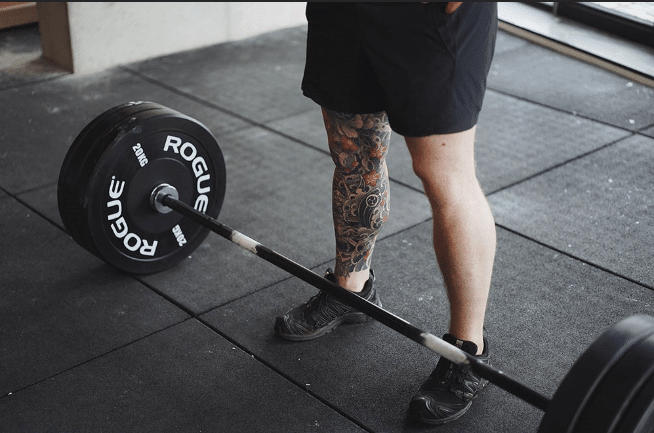 Man doing Romanian Deadlift in gym